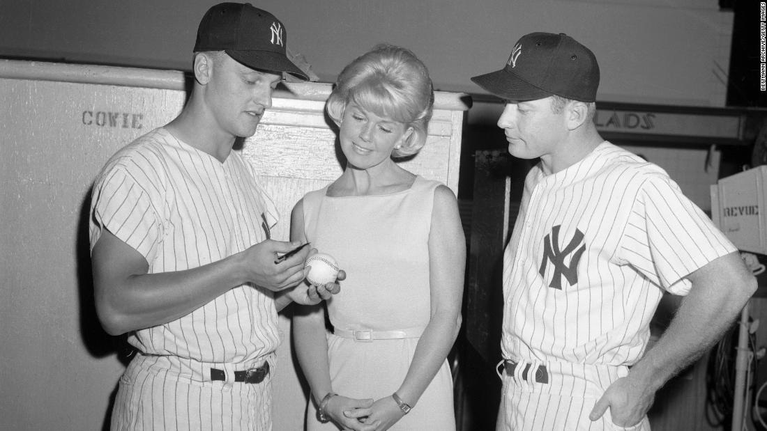 Baseball stars Roger Maris, left, and Mickey Mantle talk with Day on the set of &quot;That Touch of Mink&quot; in 1961.