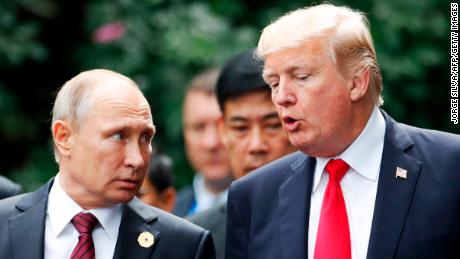 US President Donald Trump (R) and Russia&#39;s President Vladimir Putin talk as they make their way to take the &quot;family photo&quot; during the Asia-Pacific Economic Cooperation (APEC) leaders&#39; summit in the central Vietnamese city of Danang on November 11, 2017.
World leaders and senior business figures are gathering in the Vietnamese city of Danang this week for the annual 21-member APEC summit. / AFP PHOTO / POOL / JORGE SILVA        (Photo credit should read JORGE SILVA/AFP/Getty Images)