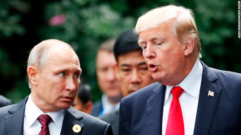 US President Donald Trump (R) and Russia&#39;s President Vladimir Putin talk as they make their way to take the &quot;family photo&quot; during the Asia-Pacific Economic Cooperation (APEC) leaders&#39; summit in the central Vietnamese city of Danang on November 11, 2017. World leaders and senior business figures are gathering in the Vietnamese city of Danang this week for the annual 21-member APEC summit. / AFP PHOTO / POOL / JORGE SILVA (Photo credit should read JORGE SILVA/AFP/Getty Images)