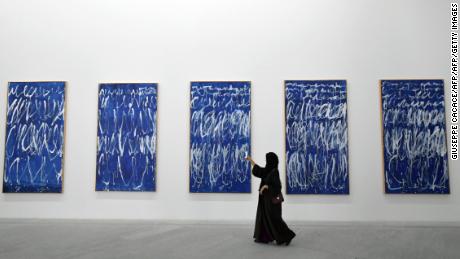 A visitor takes a photo of a piece of a series of nine panels titled &quot;Untitled I-IX&quot; by American artist Cy Twombly at the Louvre Abu Dhabi Museum on November 11.