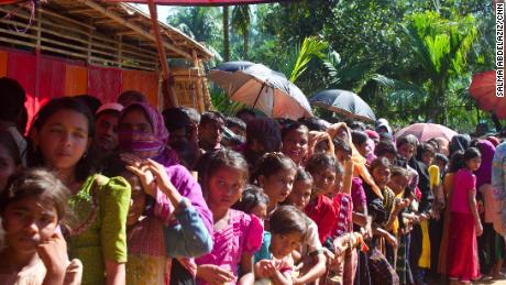 Women and girls wait for food aid in the Kutupalong refugee camp. The lines are segregated by gender.
