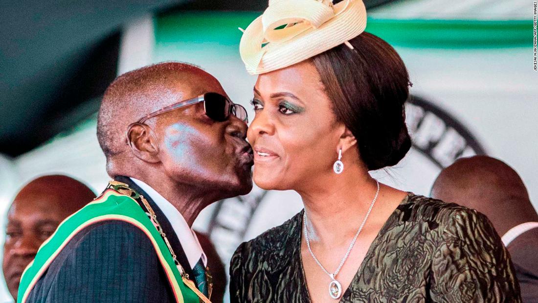 Former President Robert Mugabe kisses his wife and former first lady Grace Mugabe during the country&#39;s 37th Independence Day celebrations in 2017.