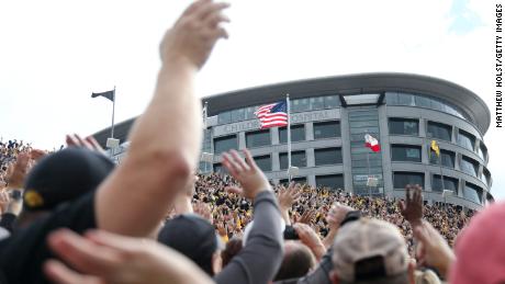 Fans at Iowa&#39;s Kinnick Stadium wave to the children watching from the nearby University of Iowa Stead Family Children&#39;s Hospital. 