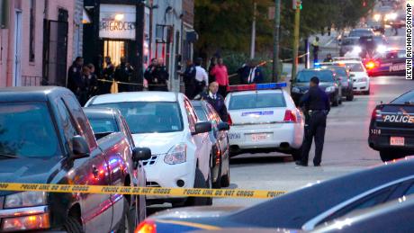 Police officers respond to Bennett Place and N. Fremont Avenue after a call went out that an officer is shot Wednesday, Nov. 15, 2017, in Baltimore, M.D.  (Kevin Richardson/The Baltimore Sun via AP)