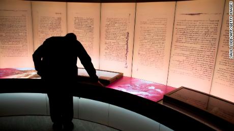 A visitors looks at an exhibit about the Dead Sea Scrolls during a media preview of the new Museum of the Bible.