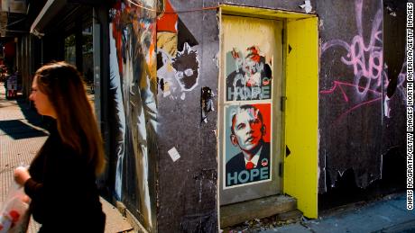 A pedestrian walks past a poster of Barack Obama  October 9, 2008 in New York City.