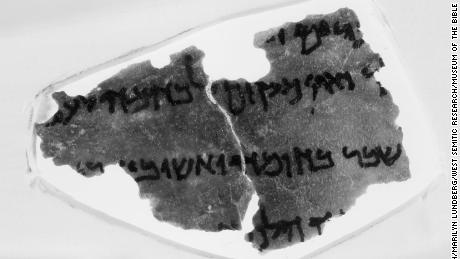 A fragment from the Museum of the Bible&#39;s collection of Dead Sea Scrolls. In this fragment, a snippet of text from the Book of Nehemiah, some scholars say they see an annotation from a 1937 edition of the Hebrew Bible, an obvious anachronism. The mark, which looks like a bitten apple, is on the far left of the third line of text.