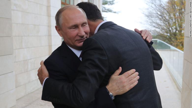 Russia&#39;s President Vladimir Putin embraces his Syrian counterpart Bashar al-Assad during a meeting in Sochi.