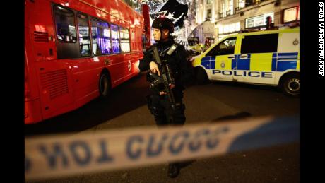 Armed police officers are seen near Oxford Circus underground station. Police were responding to reports of an incident.