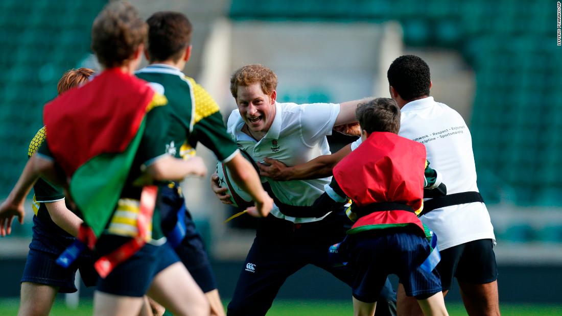 Harry plays rugby with children as he takes part in a coaching session in London in 2013.