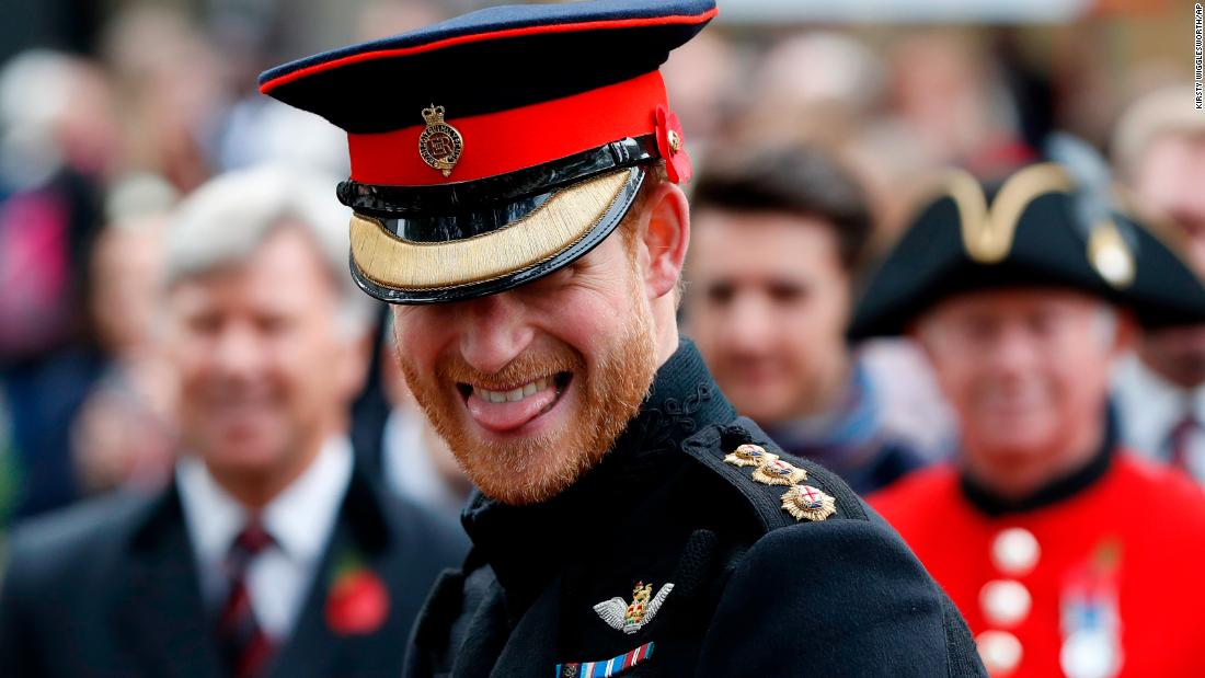 Harry smiles as he speaks to veterans in London in November. He was attending the official opening ceremony of the Field of Remembrance at Westminster Abbey.
