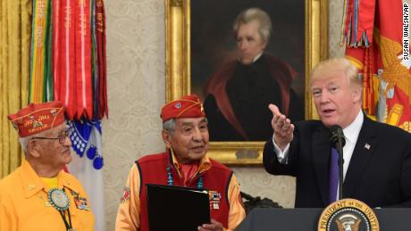 President Donald Trump speaks during a meeting with Navajo Code Talkers Fleming Begaye Sr., seated left, Thomas Begay, second from left, and Peter MacDonald, second from right, in the Oval Office of the White House on Nov. 27.