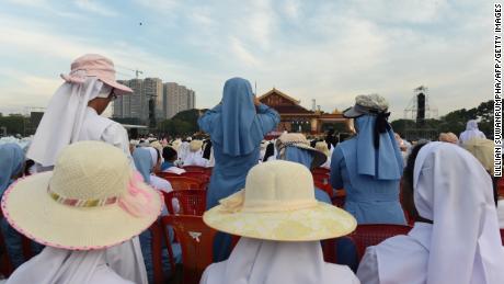 Nuns take photos prior to an open air mass by pope Francis in Yangon.