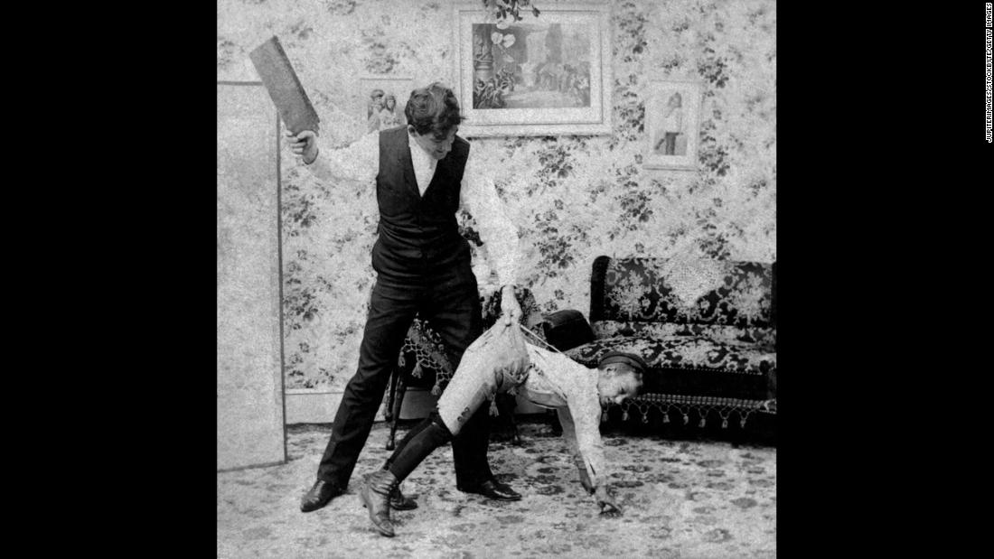 The tools of spanking are varied. In this vintage image, a man uses a paddle. For adults administering punishment,&lt;strong&gt; &lt;/strong&gt;the use of switches, belt straps, paddles and the like delivered increased punishment while saving their hands from the sting of the swat. &lt;br /&gt;In the slave trade, there was a crueler reason for the use of a paddle or strap. In his book &quot;&lt;a href=&quot;https://books.google.com/books?id=R-BAAAAAcAAJ&amp;printsec=frontcover&amp;pg=PA304#v=onepage&amp;q&amp;f=false&quot; target=&quot;_blank&quot;&gt;Flagellation and the Flagellants: A History of the Rod in all Countries from the Earliest Period to the Present Time&lt;/a&gt;,&quot; the Rev. William Cooper explains that straps were used to keep from scarring slaves and reducing their value: &quot;It is said that with this instrument a slave could be punished to within an inch of his life, and yet come out with no visible injury, and with his skin as smooth as a peeled onion.&quot;