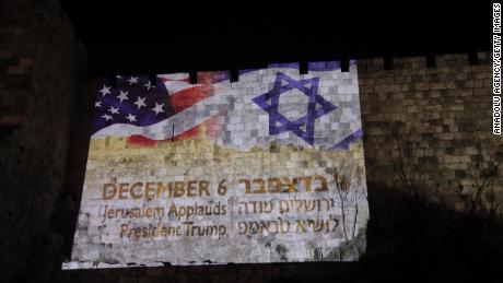 Flags of the United States and Israel are reflected on wallss around the Old City of Jerusalem.