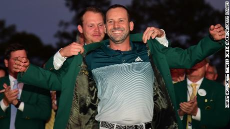 AUGUSTA, GA - APRIL 09:  Danny Willett of England presents Sergio Garcia of Spain with the Green Jacket after Garcia won in a playoff during the final round of the 2017 Masters Tournament at Augusta National Golf Club on April 9, 2017 in Augusta, Georgia.  (Photo by Harry How/Getty Images)