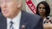 Omarosa Manigault (R), White House Director of Communications for the Office of Public Liaison, sits behind US President Donald Trump as he speaks during a meeting with teachers, school administrators and parents in the Roosevelt Room of the White House in Washington, DC, February 14, 2017. / AFP / SAUL LOEB        (Photo credit should read SAUL LOEB/AFP/Getty Images)