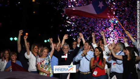Chilean President-elect Sebastian Pinera, surrounded by family and supporters, celebrates his victory outside a Santiago hotel on December 17.