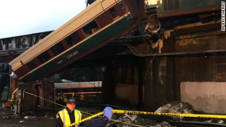 NS Slug: WA:AMTRAK DERAILMENT-TRAIN TRUCK UNDER BRIDGE  Synopsis: Deaths reported aboard Amtrak train that derailed over Washington state highway  Video Shows: Train truck under bridge, train car hanging from overpass    Keywords: WASHINGTON TRAIN PIERCE COUNTY