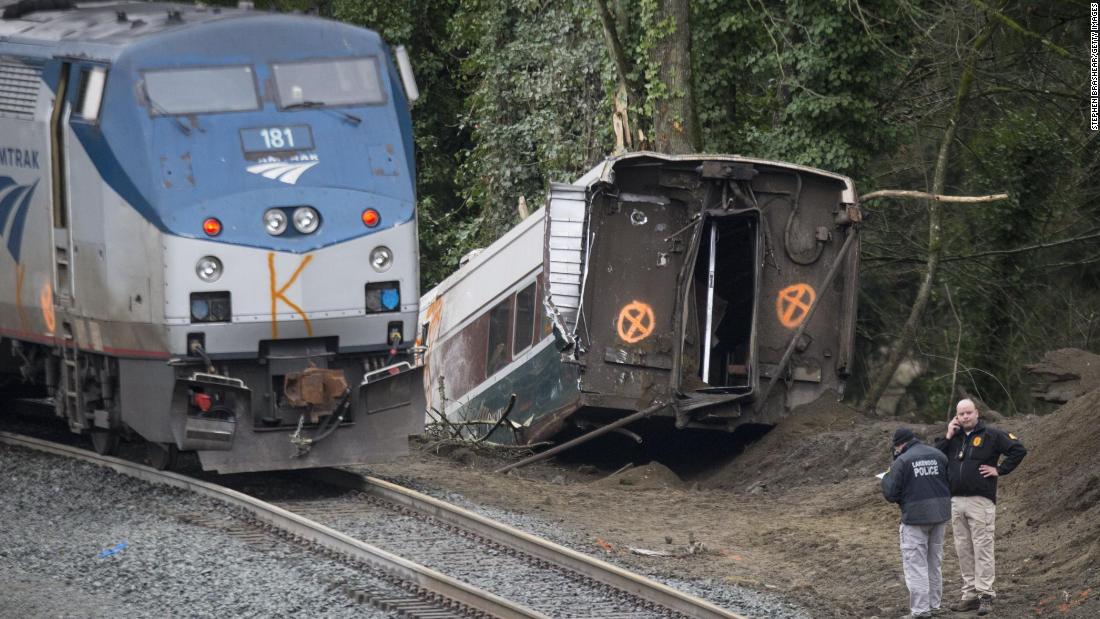 Law enforcement officials work at the scene of the derailment on December 18. The train was making the first trip of a new route that goes from Seattle to Portland, Oregon.