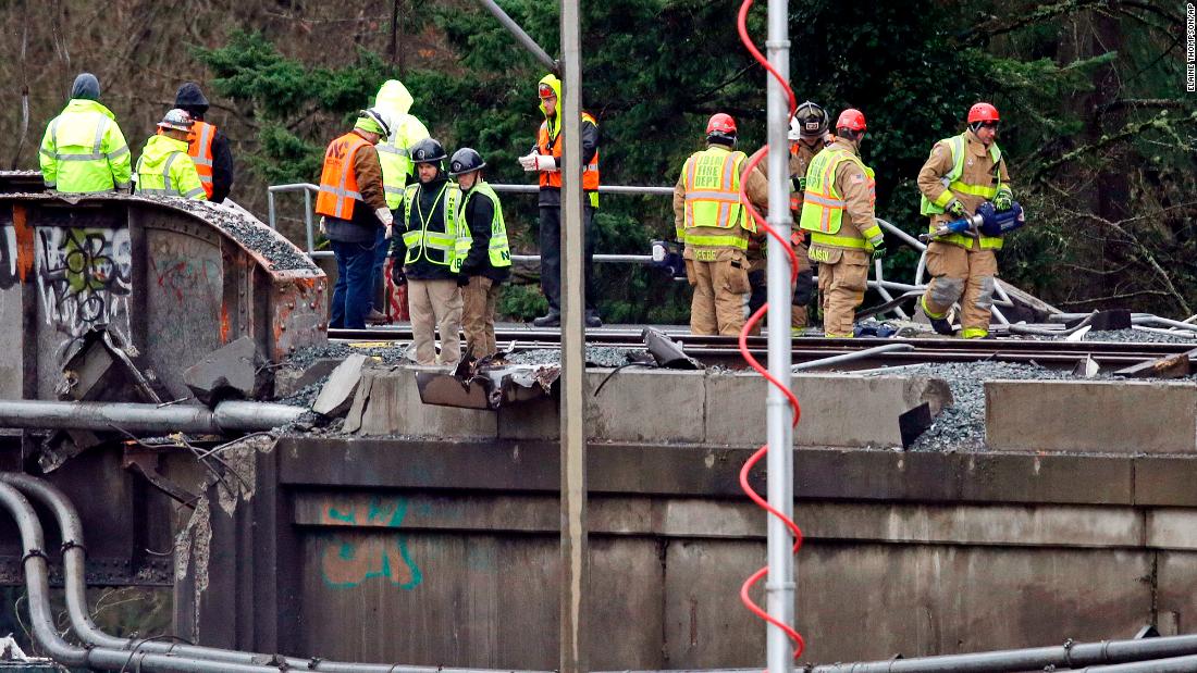 Men work at the scene of the derailment on December 19.