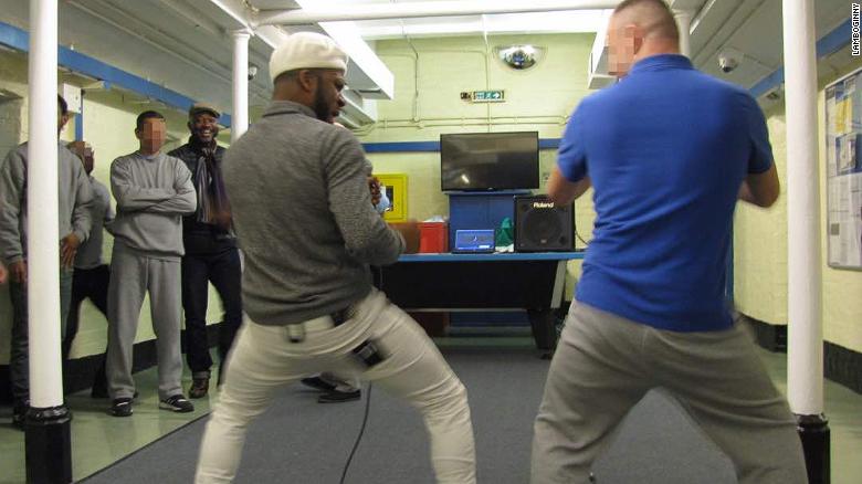 Lamboginny performs at Leicester prison, in the UK, with one of the prison inmates, while other inmates look on. He was invited to perform there in November 2017.