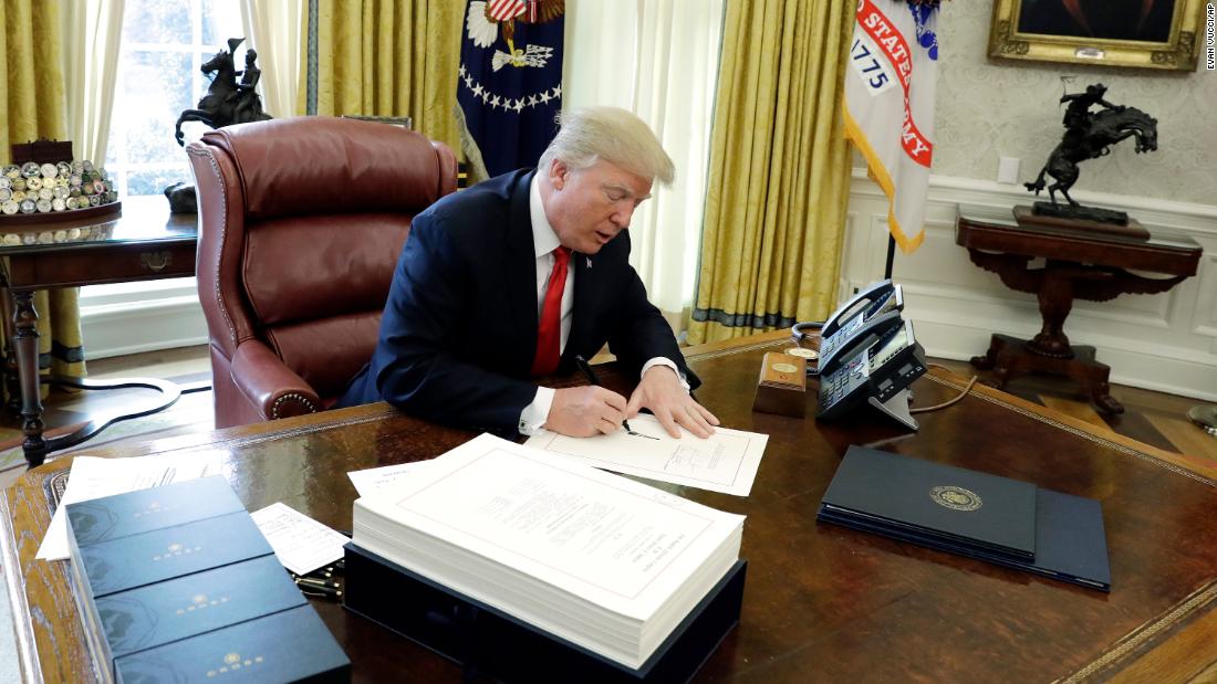 Trump signs tax bill before Mar-a-Lago trip