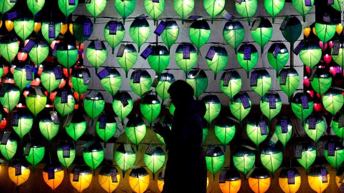 A woman prays in front of lanterns to celebrate the New Year at Jogyesa Buddhist temple in Seoul, South Korea.