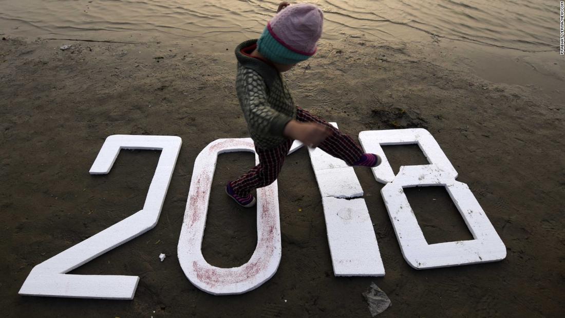 A child walks on numbers reading &quot;2018&quot; in Allahabad, India.