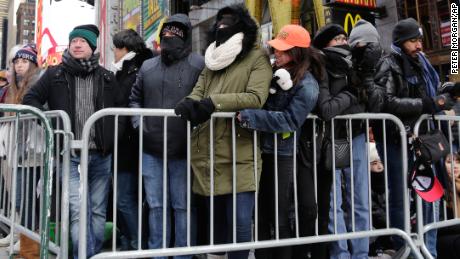 New Yorkers, celebrity entertainers and tourists from around the world packed into Times Square Sunday for what&#39;s expected to be a flashy but frigid celebration.