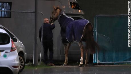 A horse is led away during the Liverpool International Horse Show held at the Echo Arena following a blaze at a multi-storey car park nearby.