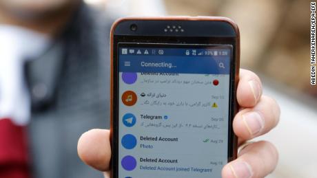 An Iranian man shows his phone as certain apps were restricted in Tehran on Tuesday. 