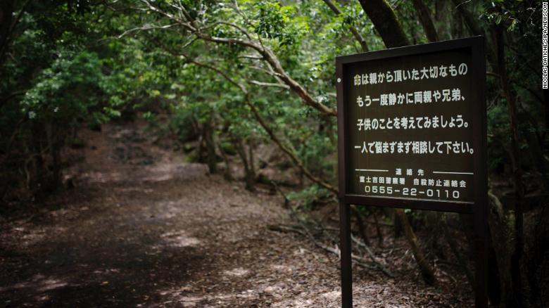 A sign at the entrance of the Aokigahara forest urges suicidal visitors to reach out for help.