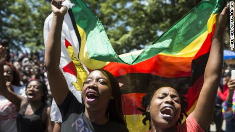 Demonstrators call for the resignation of Zimbabwe&#39;s former President Robert Mugabe. Will they see genuine democracy in 2018?