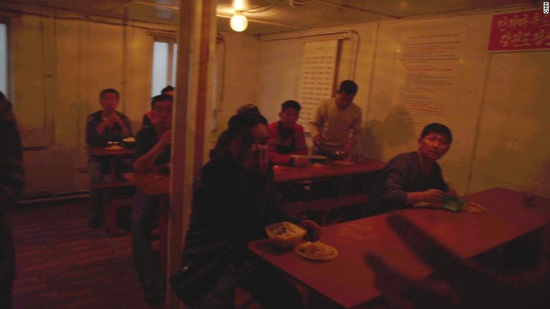 North Korean workers eat lunch in their canteen.