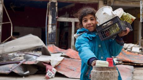 A young girl in the town of Maraat Nouman with her haul for the day. She&#39;s just finished picking through the garbage around the site of a recent airstrike for reusable plastic.