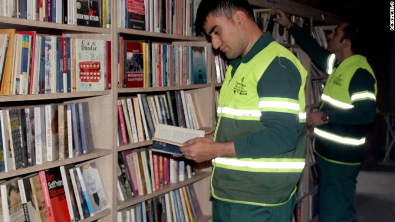 Garbage collectors in Ankara, Turkey browse for books at a library made up entirely of abandoned books.