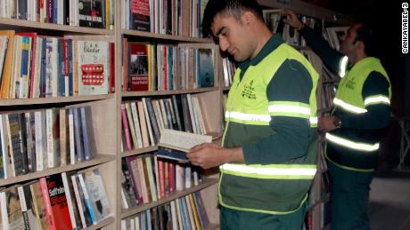 Garbage collectors in Ankara, Turkey browse for books at a library made up entirely of abandoned books.