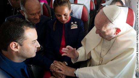 Pope Francis marries flight attendants Carlos Ciuffardi, left, and Paola Podest, center, during a flight from Santiago, Chile, to Iquique, Chile, Thursday, Jan. 18, 2018. Pope Francis celebrated the first-ever airborne papal wedding, marrying these two flight attendants from Chile&#39;s flagship airline during the flight. The couple had been married civilly in 2010, however, they said they couldn&#39;t follow-up with a church ceremony because of the 2010 earthquake that hit Chile. (L&#39;Osservatore Romano Vatican Media/Pool Photo via AP)