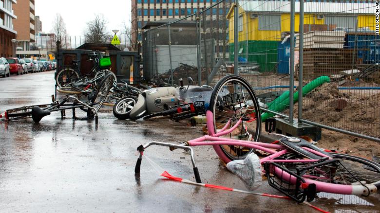 Bicycles and a scooter overturned by heavy winds lie in a street in Amsterdam, Netherlands, Thursday, Jan. 18, 2018.