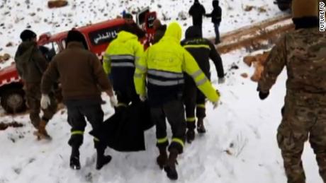 Emergency workers remove the bodies of Syrians found inside Lebanon in a mountainous region near the border. 