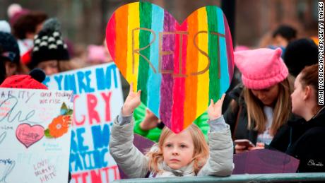 A girl holds up a sign during a rally attended by thousands of demonstrators at Cambridge Commons in Boston, Massachusetts on January 20, 2018. 