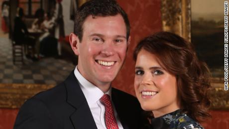 LONDON, ENGLAND -JANUARY 22: (EDITOR&#39;S NOTE: Alternative crop of image #908732602) Princess Eugenie and Jack Brooksbank pose in the Picture Gallery at Buckingham Palace after they announced their engagement. Princess Eugenie wears a dress by Erdem, shoes by Jimmy Choo and a ring containing a padparadscha sapphire surrounded by diamonds on January 22, 2018 in London, England..  They are to marry at St George&#39;s Chapel in Windsor Castle in the autumn this year. (Photo by Jonathan Brady - WPA Pool/Getty Images)