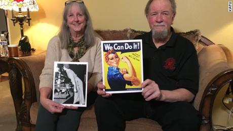 Naomi Parker Fraley&#39;s daughter-in-law and son hold up a photograph of her taken during World War II and the poster it inspired.