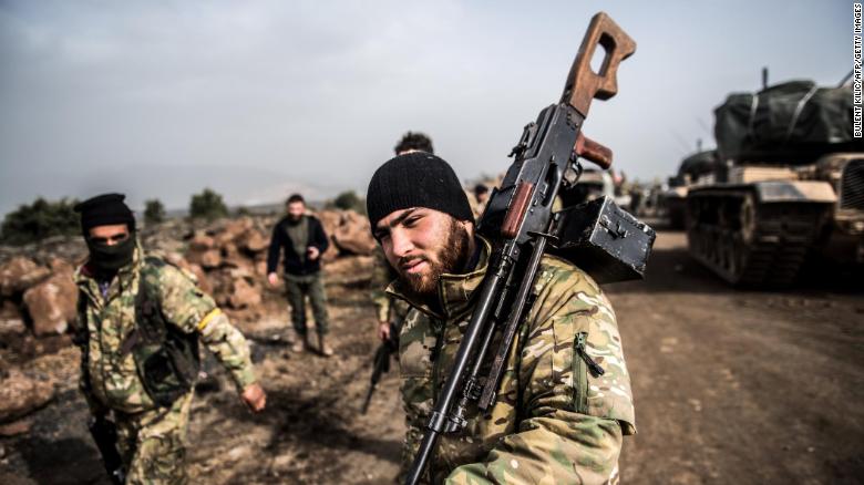 Turkish troops advance near the Syrian border at Hassa, Hatay province, on Monday.