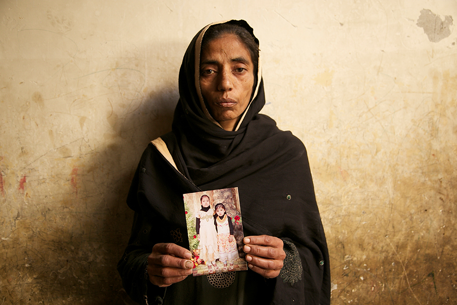 Laiba&#39;s mother Aasia Bibi, 35, holds a photo of her daughters who she hoped would one day be there to care for her.
