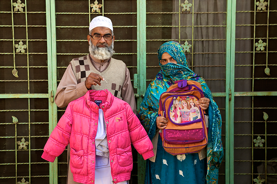The parents of Zainab Ansari -- Muhammad Amin Ansari, 48, and Nusrat Amin, 45 -- hold  their daughter&#39;s school uniform, jacket and Barbie schoolbag.