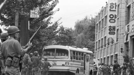 South Korean troops guard the bombed out remains for a bus hi-jacked by Unit 684 mutineers. 