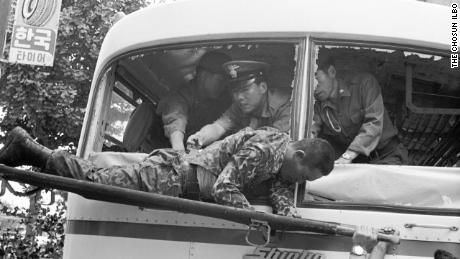 South Korean security forces carry one of the Unit 684  survivors in 1971. A 2006 Defense Ministry Truth Commision report revealed 20 mutineers were killed on board the bus. Four survivors were later executed.  