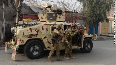 Soldiers stand behind a vehicle Wednesday in Jalalabad.